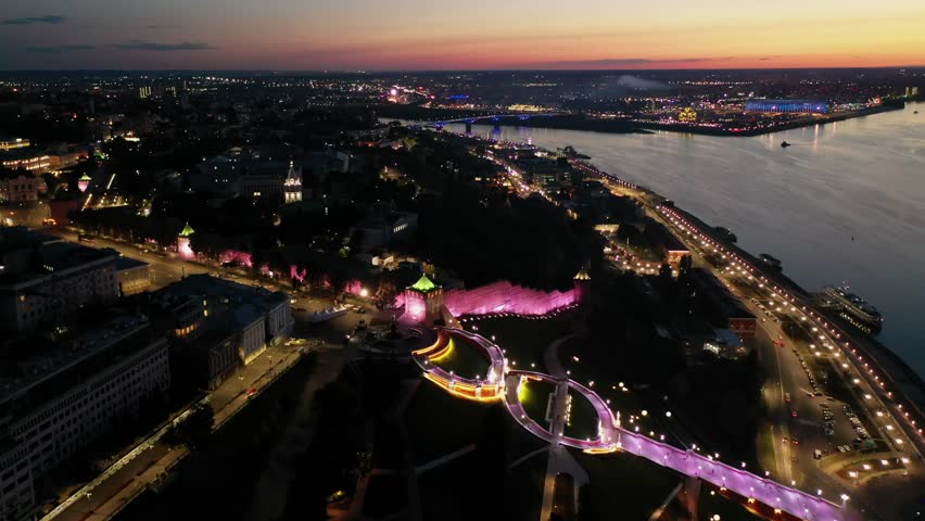 View from drone of Chkalovskaya Staircase and St George Tower of Nizhny Novgorod Kremlin at night with illumination on background with modern cityscape on banks of Volga river in summer, Russia Royalty-Free Stock Footage #1111463549