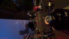 Vertical video. Evening hyperlapse of motorcycle riding in road traffic in Bangkok, Thailand. POV