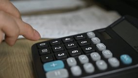 Man's hands using a calculator. Tax time.Tax concept. Close-up. - Powered by Shutterstock - Get 15% off with code: PIKWIZARD15