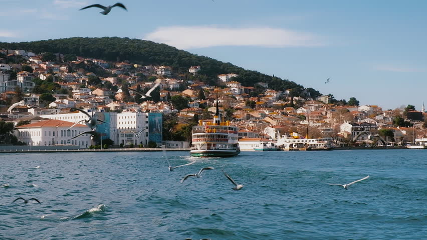 Ferry boat on background of coastline with beautiful tiny houses on Island Burgazada in the Sea of Marmara, one of the Princes' Islands, Istanbul, Turkey. High quality FullHD footage Royalty-Free Stock Footage #1111470379