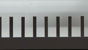 falling line of wooden domino blocks each knocking the next over, domino effect slow motion - Powered by Shutterstock - Get 15% off with code: PIKWIZARD15