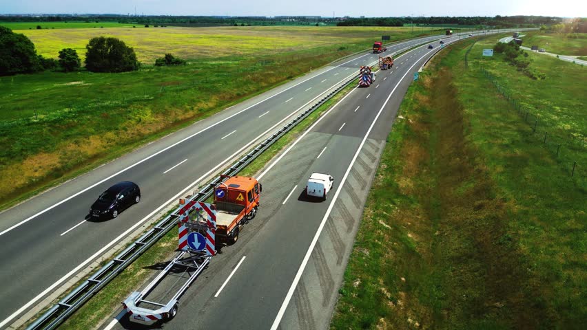 Maintenance and service over the road. Special equipment cuts the grass near the highway. Aerial view. 4k footage | Shutterstock HD Video #1111476285