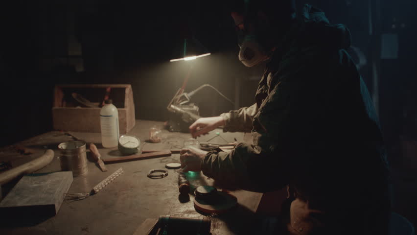 Bomb maker screwing something in the warehouse