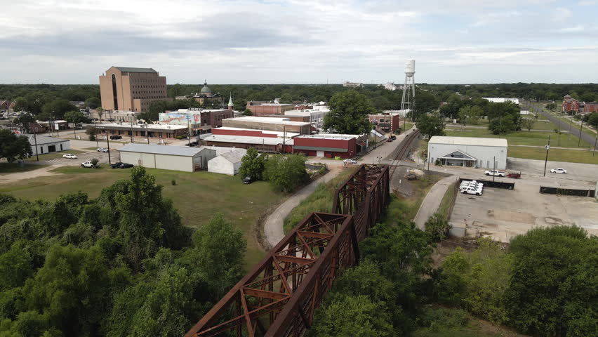 Passenger Train Crossing Bridge in Small Town in Texas USA