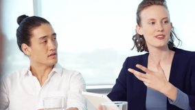 Animation of connected cart and lock icons over diverse woman with tablet explaining to colleagues. Digital composite, shopping, retail, protect, security, meeting, discussion, technology, office. - Powered by Shutterstock - Get 15% off with code: PIKWIZARD15