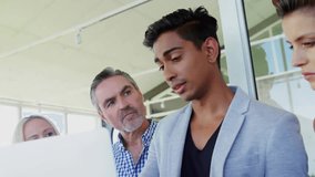 Animation of infographic interface over diverse businessman explaining over laptop to colleagues. Digital composite, business, report, progress, teamwork, technology, discussion, office. - Powered by Shutterstock - Get 15% off with code: PIKWIZARD15