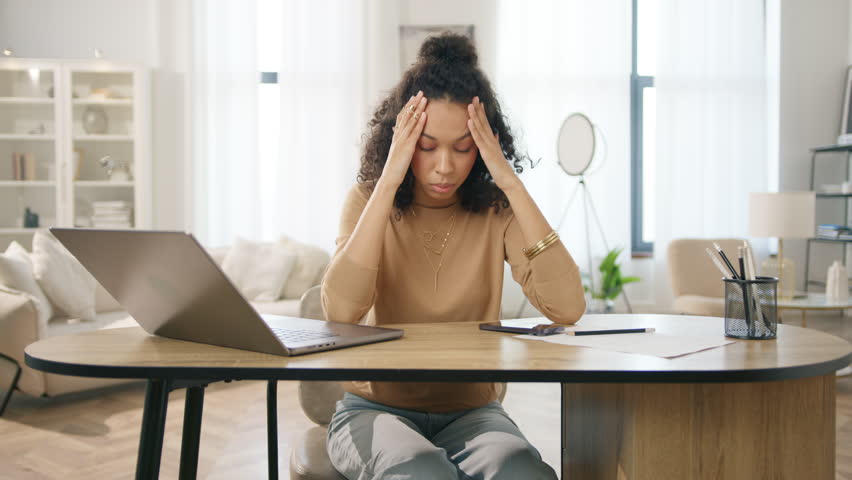 Sad tired woman overworked on computer. Unhappy frustrated businesswoman working remotely at home office. Tired diverse model workaholic annoyed, overwhelmed, exhausted, stressed by deadlines 4k Royalty-Free Stock Footage #1111500213