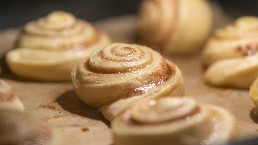 Homemade buns with cinnamon and sugar are baked in the oven. Time lapse of baking raw yeast dough until golden brown. Close-up cooking food (blurry background, shallow depth of field) Royalty-Free Stock Footage #1111500697