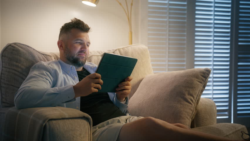 Real people choosing for movies on internet streaming service, scrolling social media 4K. Mature white man sitting on comfy sofa chair in living room at home, searching films to watch for fun online Royalty-Free Stock Footage #1111501783