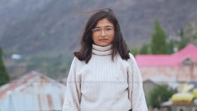 Positive serious millennial Indian girl portrait. Beautiful young adult woman looking at camera, posing outdoors. Confident Indian female model with calm expression - Powered by Shutterstock - Get 15% off with code: PIKWIZARD15