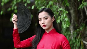 A young girl is wearing Vietnamese traditional ao dai. Video for tourism, culture, tradition, and the beauty of Asian people