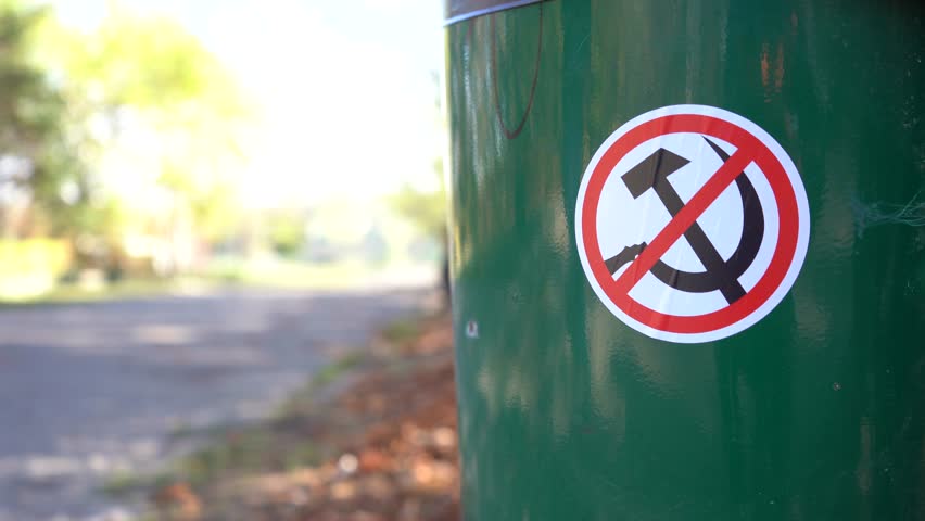 hammer and sickle. the sign forbidden to communism stuck on a public trash can. detail. 4k video. Royalty-Free Stock Footage #1111510769