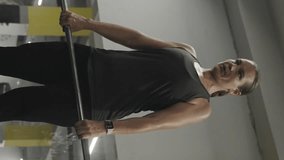 Vertical video. Camera Follows the Movements of a Young Woman Performing Romanian Deadlifts with a Barbell in the Gym! - Powered by Shutterstock - Get 15% off with code: PIKWIZARD15