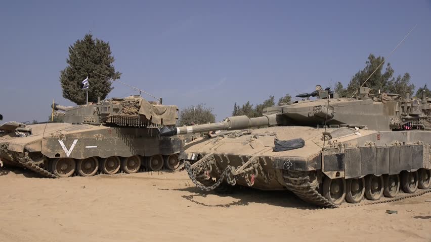 A handheld clip of two Israeli tanks, waiting for deployment on the desert soil. Kibbutz Be