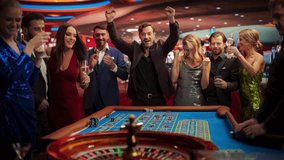 Successful Men and Women Partying in a Luxurious Casino. Young People Gambling at a Roulette Table, Putting High Stakes Bets. Entertainment Industry and Glamorous Lifestyle Concept - Powered by Shutterstock - Get 15% off with code: PIKWIZARD15