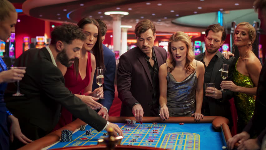 Casino Players Making Bets at a Roulette Table. Vibrant Crowd of International Young People Enjoying Nightlife in a City. Gambler Excited with Hitting the Jackpot and Winning a Big Sum of Money | Shutterstock HD Video #1111517925