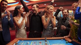 Slow Motion Footage of a Spinning Roulette Wheel. Focus Switching to Female and Male Guests Placing Risky Bets while Playing Roulette. Crowd Celebrating a Positive Outcome and Cheering the Winners - Powered by Shutterstock - Get 15% off with code: PIKWIZARD15