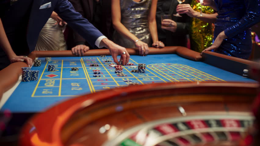 Successful Men and Women Partying in a Luxurious Casino. Young Anonymous People Gambling at a Roulette Table, Putting High Stakes Bets. Entertainment Industry and Glamorous Lifestyle Concept | Shutterstock HD Video #1111518011