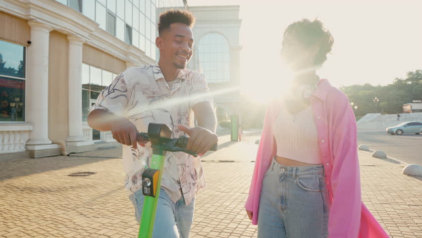 Multiracial friends communicate with each other before riding shared electric push scooters in the city. Rental electric transportation. | Shutterstock HD Video #1111524005