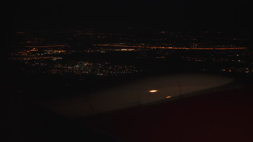 Airplane take off over night sky city lights, view from window sit. Turbine of the plane from the passenger window. White wing airplane taking off. Travel tourism concept. Aircraft vehicle transport | Shutterstock HD Video #1111524241