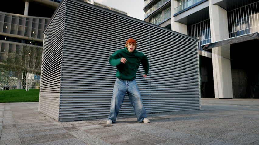 Dancing man performing various freestyle dance outdoors in street wall having fun | Shutterstock HD Video #1111524405