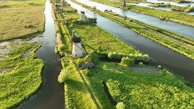 An aerial view of the windmill. Kinderdijk national park. View from a drone. Canals with water for agriculture. Fields and meadows. Landscape from the air.