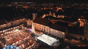 Aerial close up view of European Christmas Market old town, with Christmas carousel, ice rink, Christmas tree and Ferris wheel at night. Holidays and Christmas celebration concept in Europe - Powered by Shutterstock - Get 15% off with code: PIKWIZARD15