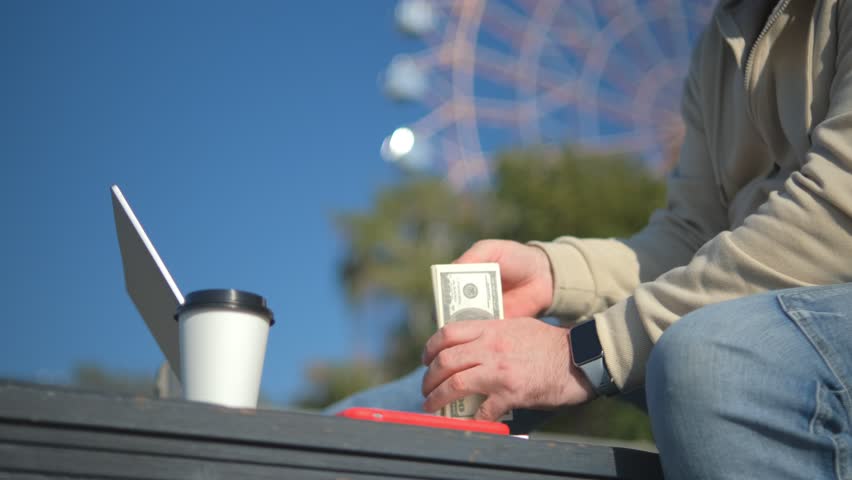 Businessman working remote with wireless portable computer typing laptop online chat browsing programmer app sitting outdoors near office company building background on