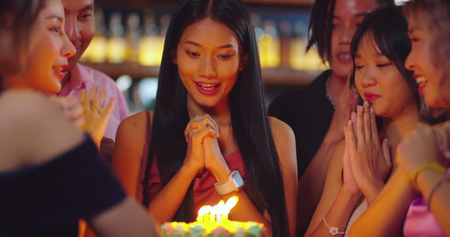 Beautiful Asian Woman is Savoring Her Birthday Festivities at a Restaurant or Bar, Surrounded by Friends Who Have Gathered to Joyfully Celebrate with Her. | Shutterstock HD Video #1111527625