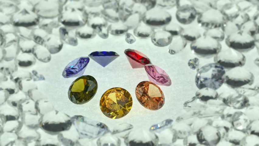 .colorful gems displayed in the middle of a white diamonds..light pendant shine on diamonds..beautiful colored diamonds surrounded by white diamonds..beautiful gems turning around. studio shoot.