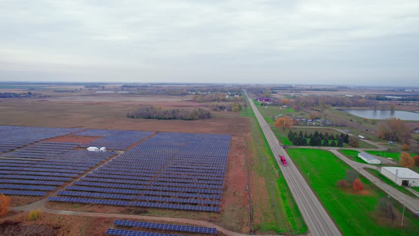 Aerial view at filed of solar panels, Atwater, Minnesota, USA, this solar farm stands as a testament to the region's commitment to renewable energy. Royalty-Free Stock Footage #1111532951