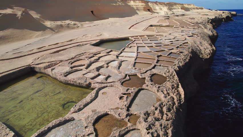 Cinematic Aerial Orbit of Salt Pans, Landmark of Gozo Island, Malta
