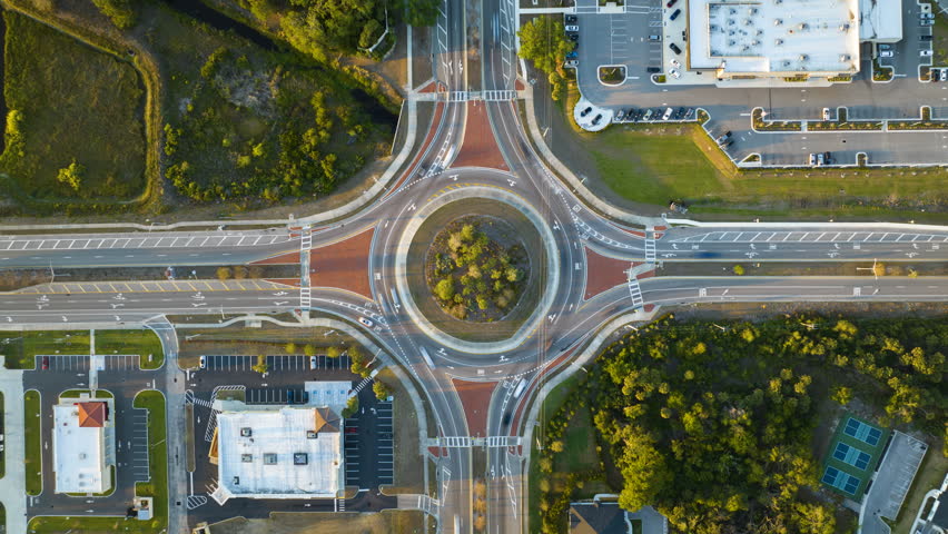 Top view of city street traffic on roundabout intersection with fast moving cars. Time-lapse of urban circular transportation crossroads Royalty-Free Stock Footage #1111533617