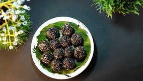 Indian Sweet sesame seeds ladoo, known as ellunda in Kerala,Seasame balls on a table Top View slow motion video, Kerala Traditional Snack