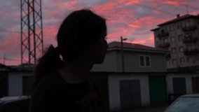 Slow motion view of a young man with a beautiful sunset in the background