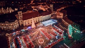 Aerial hyperlapse view of European Christmas Market old town, with Christmas carousel, ice rink, Christmas tree and Ferris wheel at night. Holidays and Christmas celebration concept in Europe - Powered by Shutterstock - Get 15% off with code: PIKWIZARD15