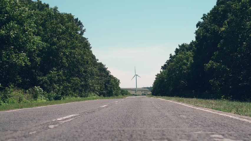 Footage of road and eolian wind turbine Royalty-Free Stock Footage #1111535683