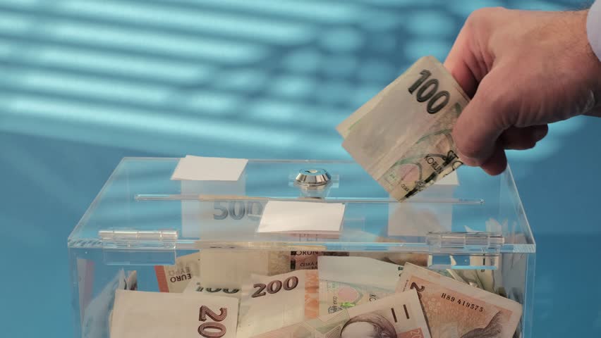 Hand put Charity and money CZK czech koruna banknotes into a transparent donation box for money donation. A financial support, collects money for a noble cause. The act of giving supports charitable i | Shutterstock HD Video #1111535769