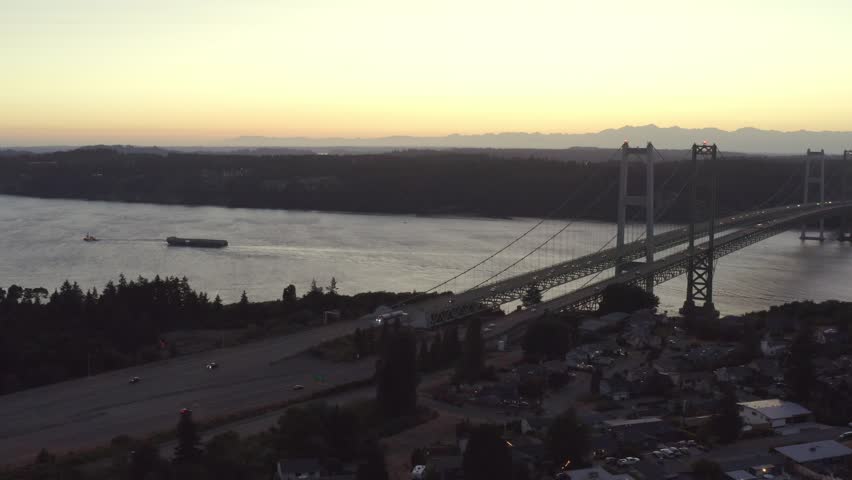 Cars Traveling Across The Twin Suspension Bridges Of Tacoma Narrows Bridge In Washington State, United States. Aerial Shot