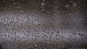 Drops of rain flow down the glass against the backdrop of moving cars. Rainy weather. Streams of water flow down the window onto the foggy glass. City rain. Meteorology. - Powered by Shutterstock - Get 15% off with code: PIKWIZARD15