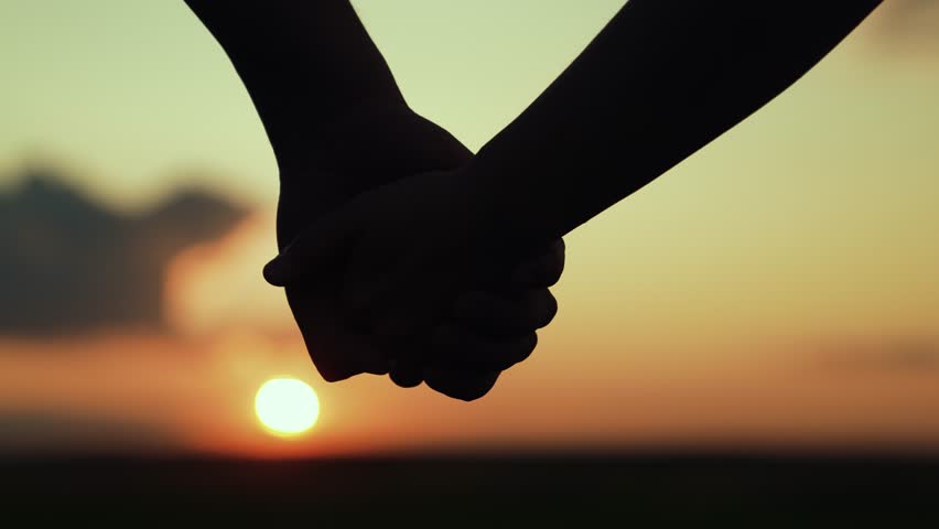 Separation of hands of man of woman. Closeup of guy lets go of girls hand, separation. Family at sunset. Pair of man, woman separate their hands in front of sun. Separation, separation, quarrel. Royalty-Free Stock Footage #1111544445