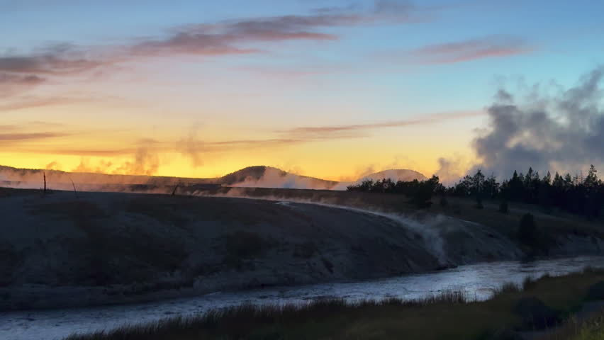 Grand Prismatic Spring dusk sunset mist steam landscape West Yellowstone National Park Old Faithful Grand loop geysers scenic Wyoming Idaho thermal colorful yellow midday cinematic slowly pan left