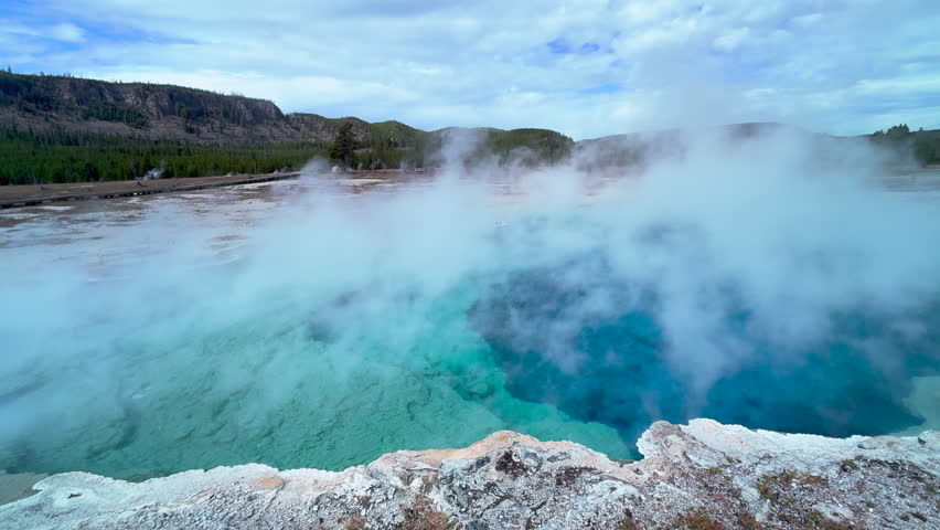 Excelsior Geyser Crater Midway Geyser Basin Grand Prismatic Spring Yellowstone National Park Old Faithful Grand loop scenic Wyoming Idaho mist steam thermal colorful aqua blue morning cinematic still Royalty-Free Stock Footage #1111546529
