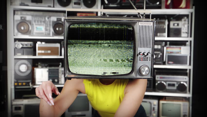 Amazing female dancer with a television as a head infront of vintage ghettoblasters