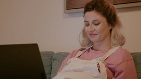 Hard working pregnant woman working at computer at home in the evening. Young pregnant freelancer woman sitting on cozy sofa at home with laptop - Powered by Shutterstock - Get 15% off with code: PIKWIZARD15