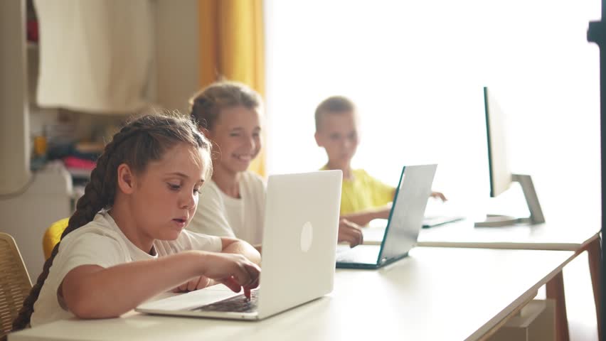 Children learn from home through computers. business concept of modern training and development. lifestyle group of little kids perform tasks in a laptop at home schooling. educating from home | Shutterstock HD Video #1111547385