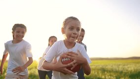 group of children run on the grass in the park with a ball. happy family childhood dream concept. children run lifestyle on the green grass and play american football together. kids have fun - Powered by Shutterstock - Get 15% off with code: PIKWIZARD15
