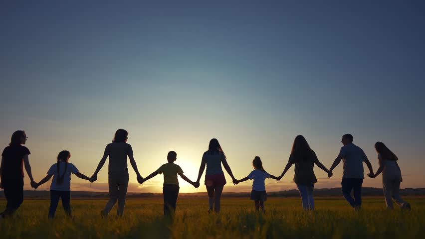Big community family in the park. silhouette of a large group of people holding hands walking at sunset in park in nature in summer. happy family kid dream concept. lifestyle big community silhouette | Shutterstock HD Video #1111547427