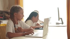 children learn from home through computers. business concept of modern training and development. group of little kids perform tasks in a laptop at home schooling. educating from home lifestyle