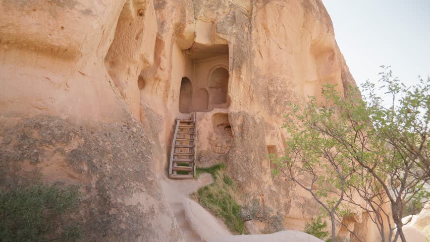 Wood ladder entrance to manmade rock cave dwelling Cappadocia landscape Royalty-Free Stock Footage #1111547923
